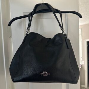 Black pebbled leather Coach Hallie shoulder bag. The purse has silver hardware.